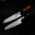 Set Yoshida : Santoku 18 cm Damas AUS-10 à manche noir et Kiritsuke 20 cm Damas VG-10, côte à côte